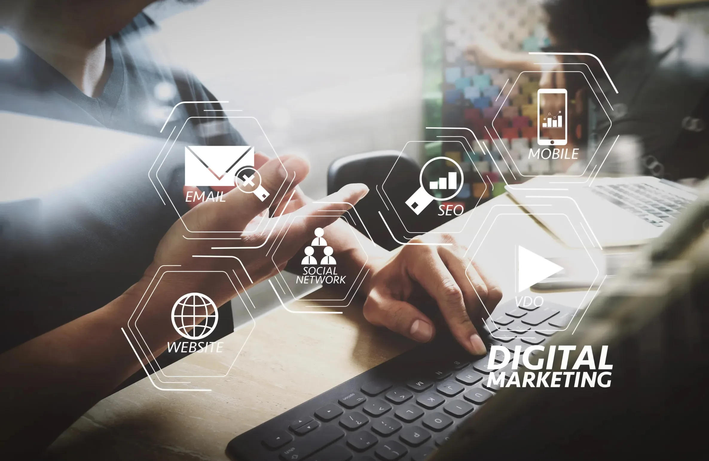A person working on a computer with digital icons for SEO, email, mobile, social network, and website — concept of Digital Marketing Trends Shaping Hyderabad in 2025.